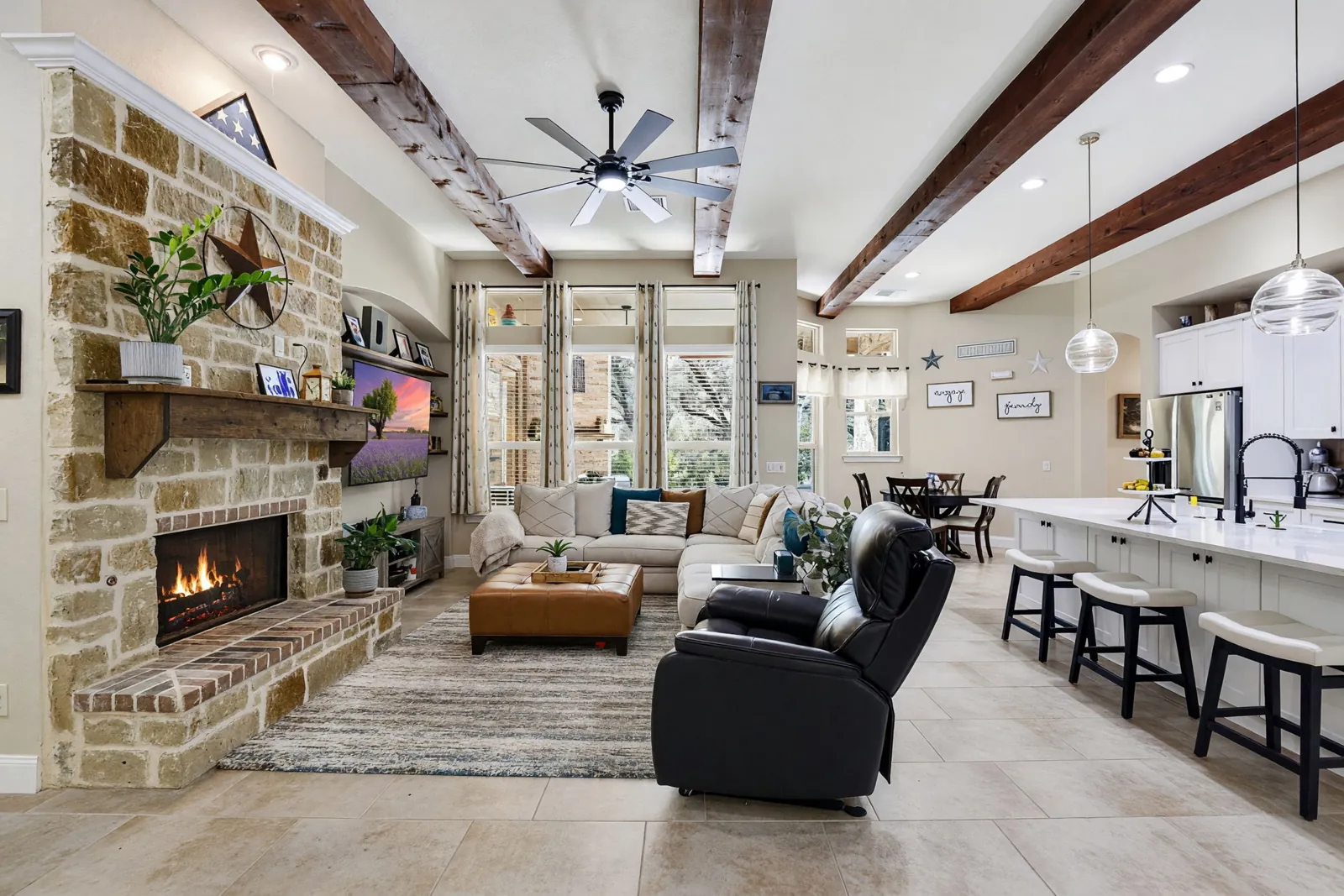 A bright living room with a stone fireplace in a Texas rental home
